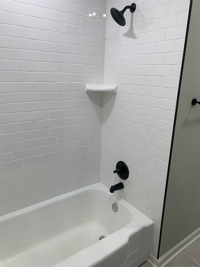 bathroom with tile patterned floors and tiled shower / bath