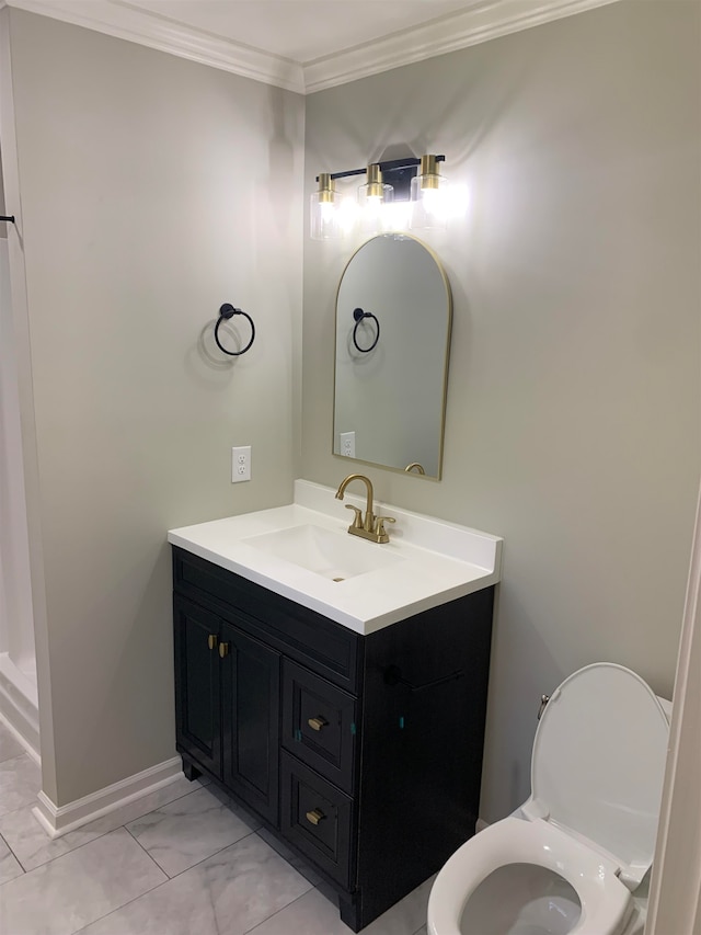 bathroom featuring toilet, vanity, and ornamental molding