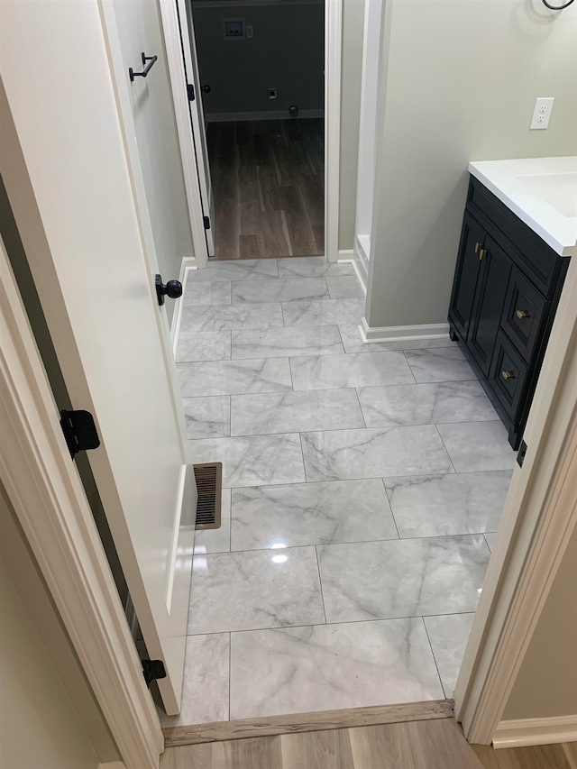 bathroom featuring hardwood / wood-style flooring and vanity