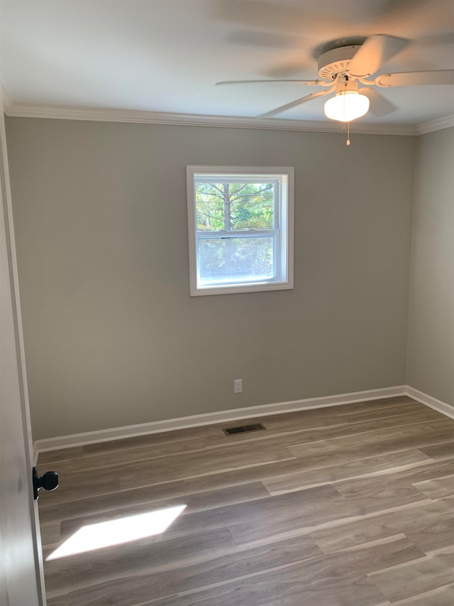 empty room featuring crown molding, ceiling fan, and hardwood / wood-style flooring