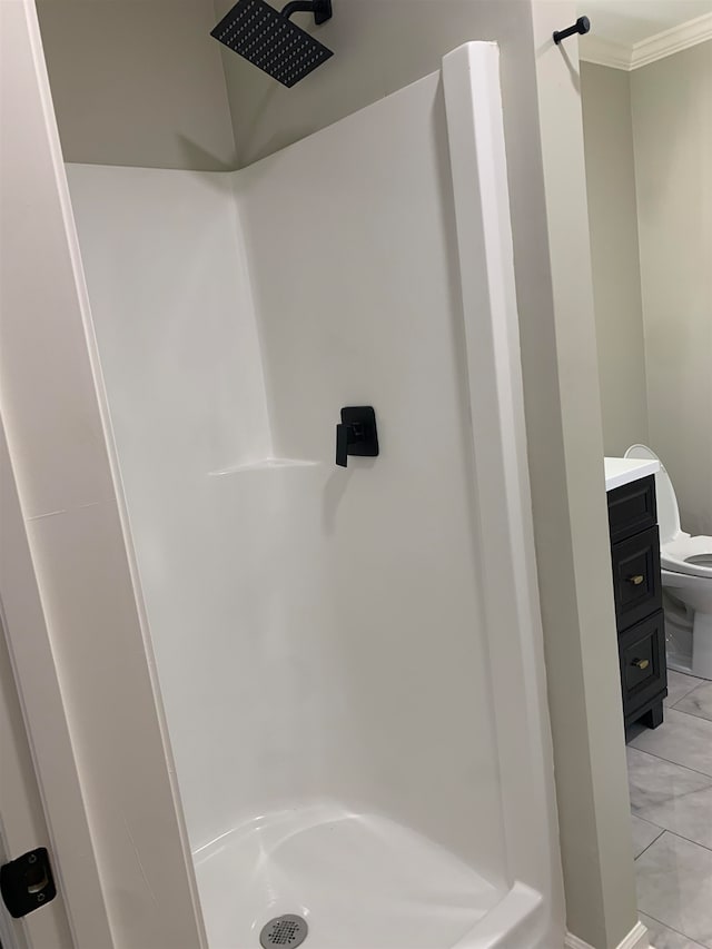 bathroom with toilet, vanity, ornamental molding, and walk in shower