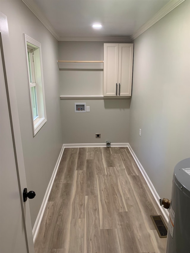 washroom with hookup for an electric dryer, hookup for a washing machine, light wood-type flooring, and ornamental molding