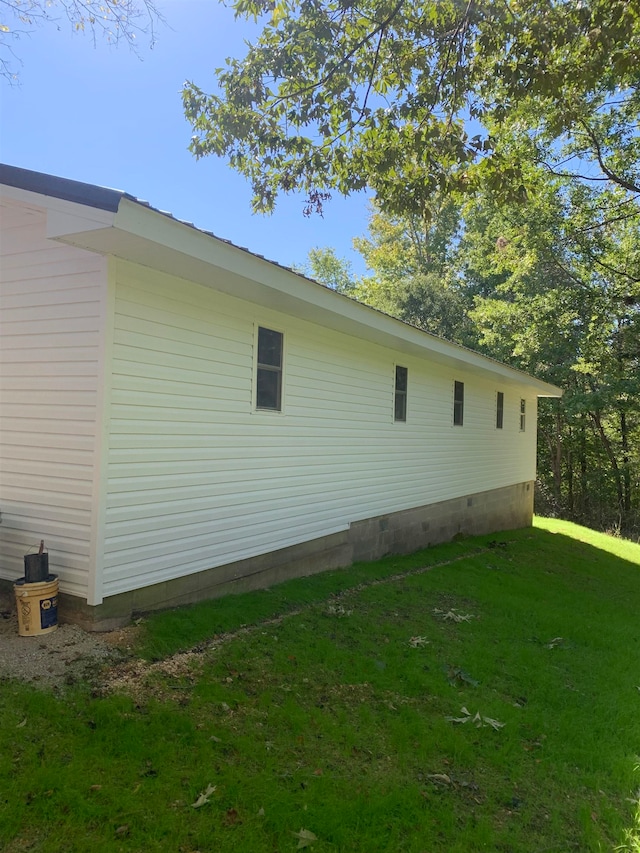 view of side of property with a lawn