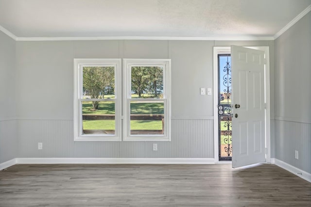 entryway with a textured ceiling, wood-type flooring, and crown molding