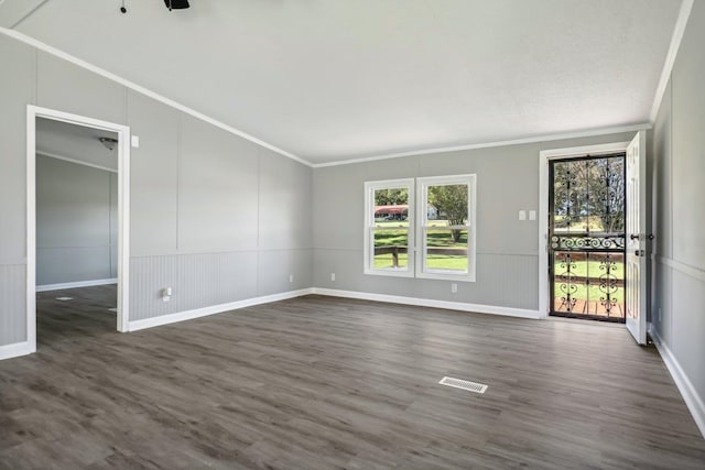 unfurnished room with dark hardwood / wood-style floors and crown molding