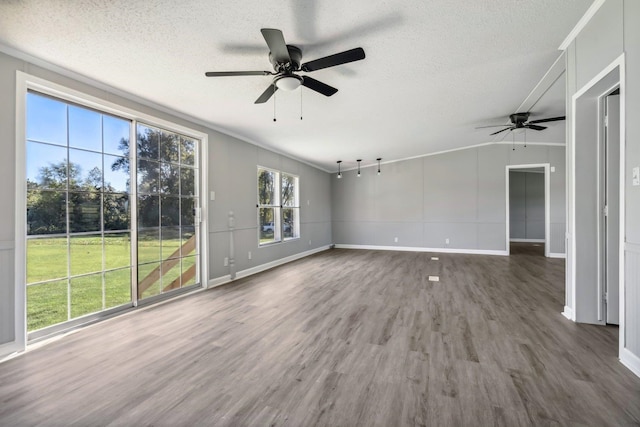 interior space featuring ceiling fan, a textured ceiling, and dark wood-type flooring