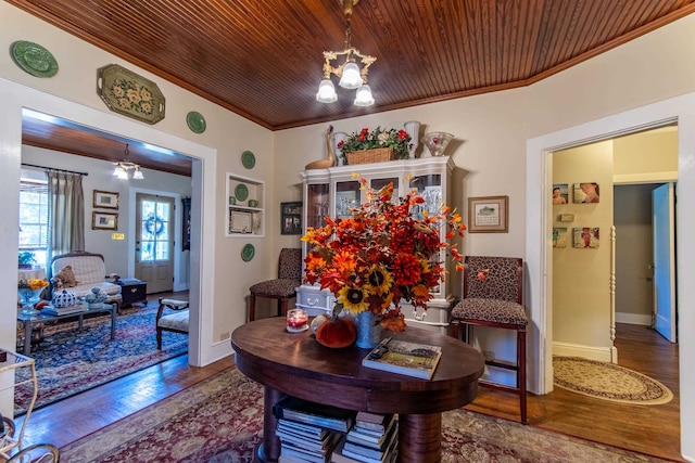 dining area with wood ceiling, dark hardwood / wood-style floors, a chandelier, and crown molding