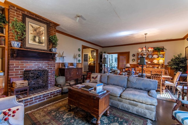 living room featuring a notable chandelier, crown molding, a textured ceiling, and a brick fireplace