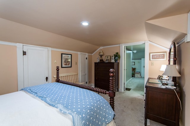 bedroom featuring vaulted ceiling and light colored carpet