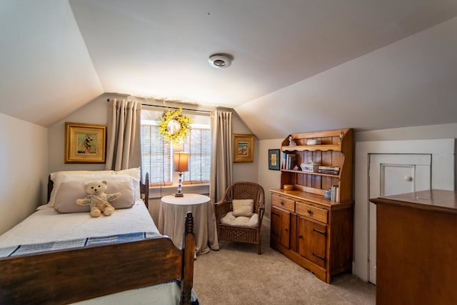 bedroom featuring light carpet and vaulted ceiling