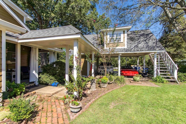 view of yard with covered porch and a carport