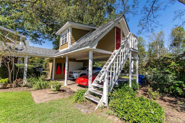 rear view of property featuring a carport and a yard