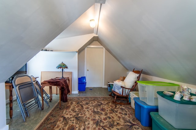 interior space with lofted ceiling and dark carpet