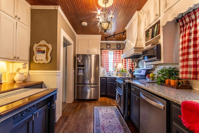 kitchen featuring appliances with stainless steel finishes, white cabinets, dark hardwood / wood-style flooring, wooden ceiling, and ornamental molding