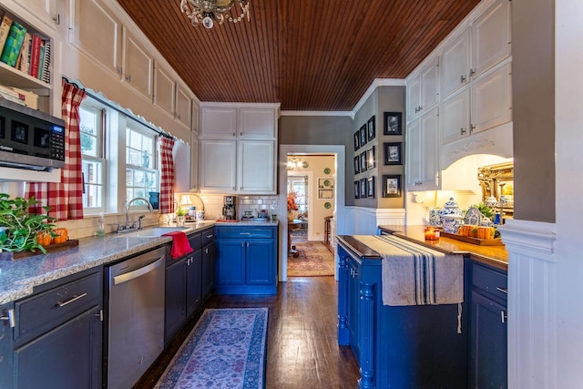 kitchen featuring appliances with stainless steel finishes, white cabinetry, blue cabinetry, crown molding, and dark hardwood / wood-style floors