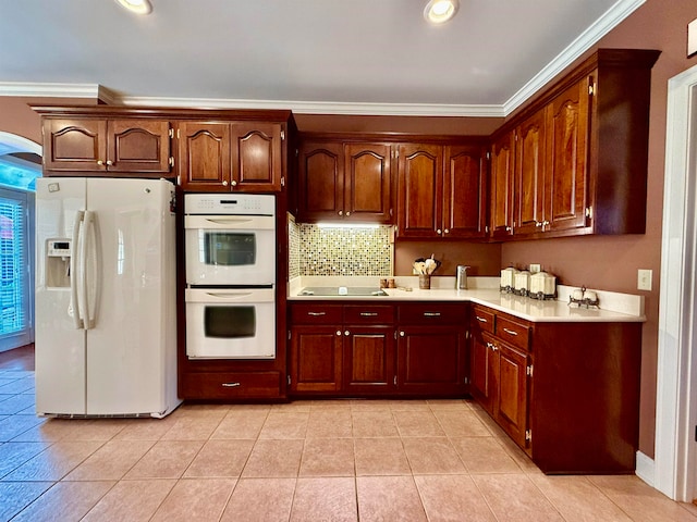 kitchen with light tile patterned floors, backsplash, ornamental molding, and white appliances