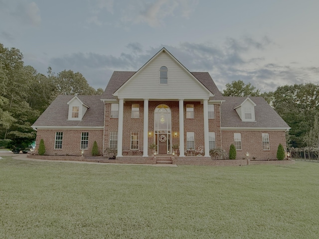 greek revival inspired property with a front lawn