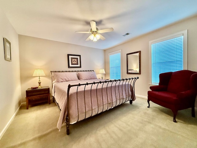 bedroom featuring light carpet and ceiling fan