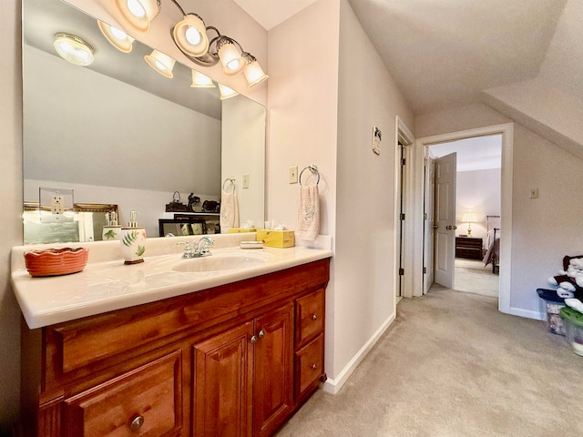 bathroom featuring vanity and vaulted ceiling