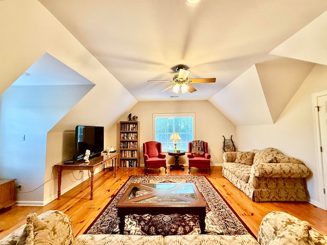 living room featuring wood-type flooring, vaulted ceiling, and ceiling fan