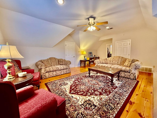 living room with vaulted ceiling, ceiling fan, and hardwood / wood-style flooring