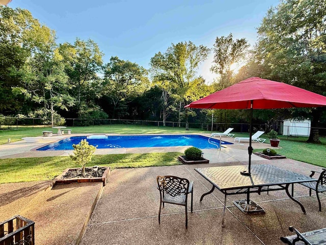 view of swimming pool with a patio area and a yard