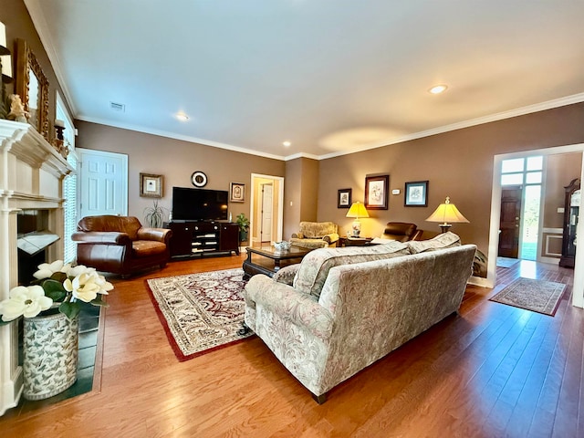 living room with hardwood / wood-style flooring and ornamental molding