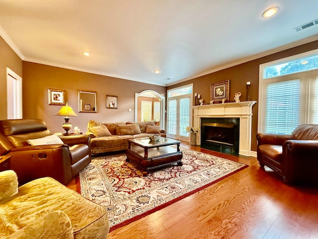 living room featuring crown molding and hardwood / wood-style floors