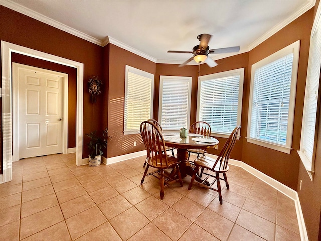 tiled dining area featuring ceiling fan and ornamental molding