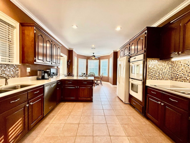 kitchen featuring white appliances, kitchen peninsula, sink, and crown molding