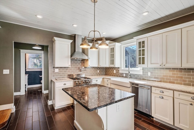 kitchen featuring stainless steel dishwasher, wall chimney exhaust hood, dark stone countertops, and dark wood-type flooring