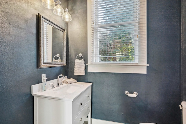 bathroom featuring vanity and toilet