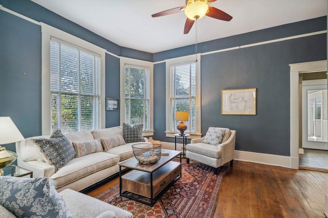 living room with ceiling fan, dark wood-type flooring, and a healthy amount of sunlight