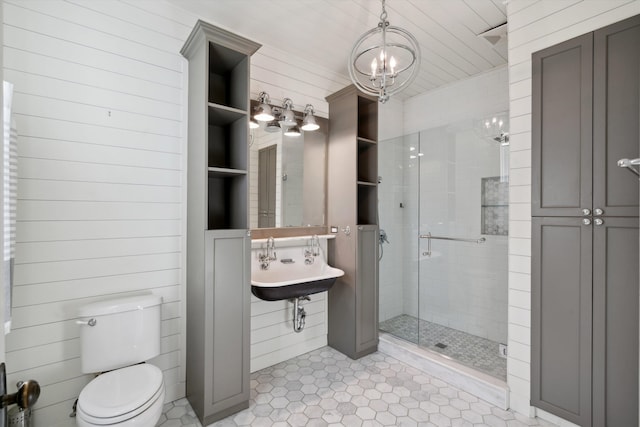 bathroom featuring wood ceiling, sink, wooden walls, a shower with shower door, and toilet