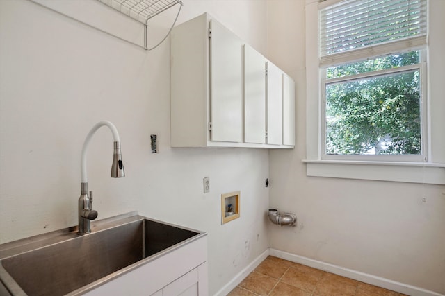 washroom featuring washer hookup, cabinets, sink, electric dryer hookup, and light tile patterned floors