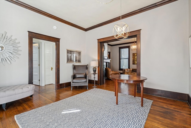 interior space featuring ornamental molding, a chandelier, and dark wood-type flooring