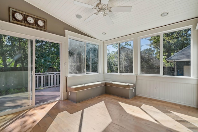 unfurnished sunroom featuring ceiling fan, vaulted ceiling, and wooden ceiling