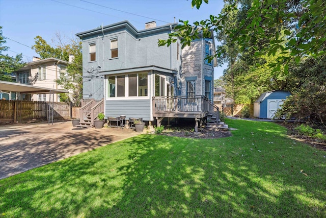 rear view of house with a storage unit, a patio, a deck, and a yard