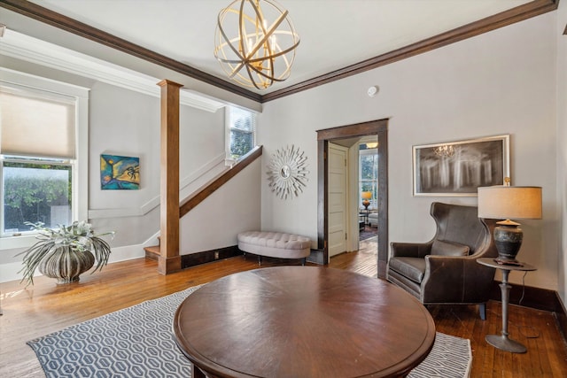 sitting room with hardwood / wood-style floors, a healthy amount of sunlight, and crown molding