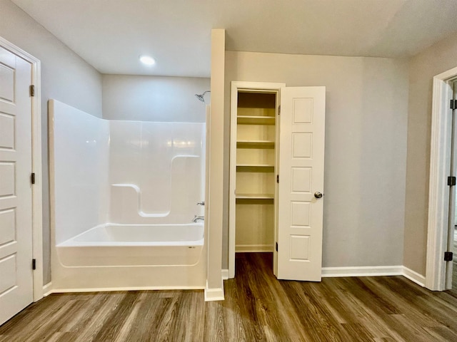 bathroom with hardwood / wood-style floors and shower / bathtub combination