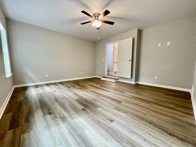 spare room with ceiling fan and hardwood / wood-style flooring