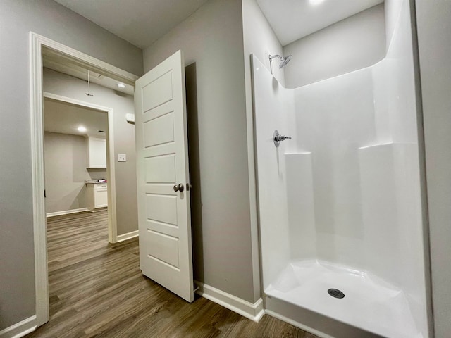 bathroom featuring hardwood / wood-style flooring and a shower