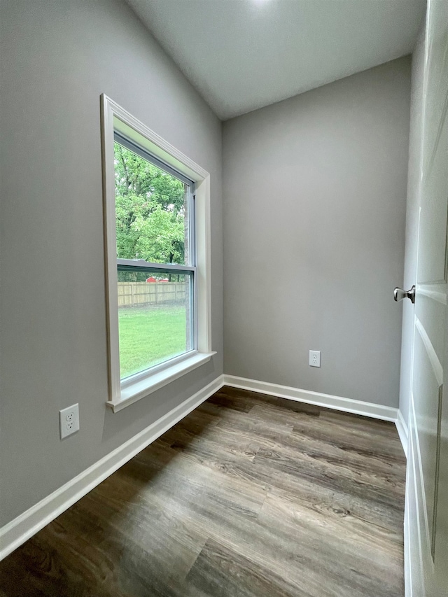 unfurnished room with hardwood / wood-style flooring