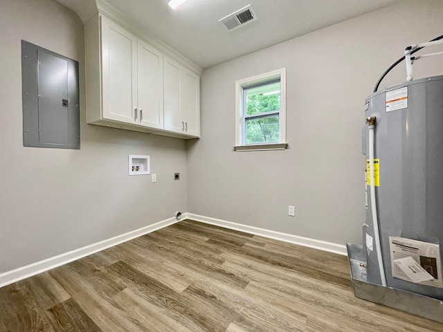 laundry room with gas water heater, light wood-type flooring, electric dryer hookup, cabinets, and electric panel