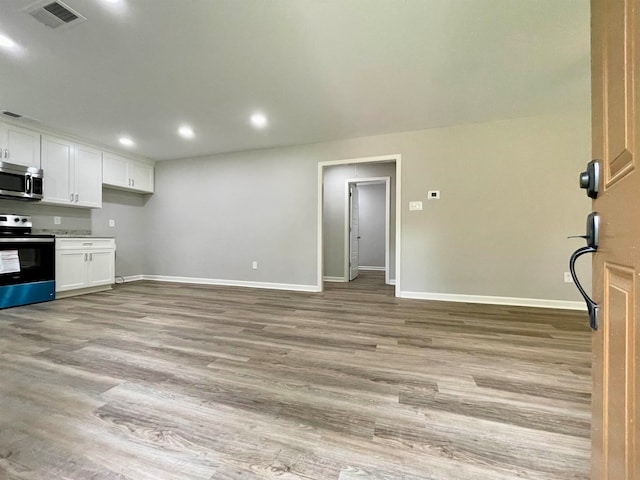 kitchen featuring light hardwood / wood-style floors, stainless steel appliances, and white cabinets