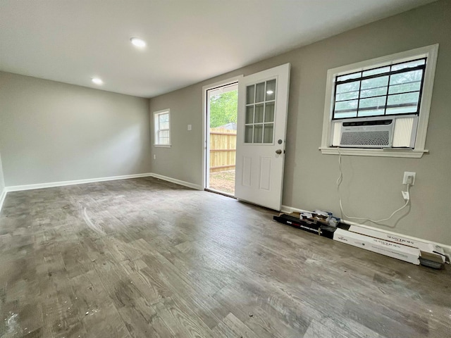 interior space featuring cooling unit, hardwood / wood-style floors, and a wealth of natural light