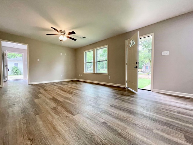 interior space with ceiling fan, hardwood / wood-style floors, and a wealth of natural light