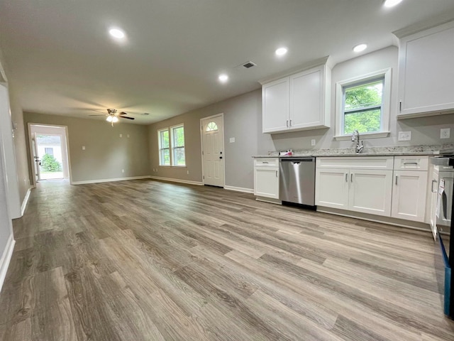 kitchen with plenty of natural light, dishwasher, and white cabinets