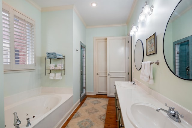 bathroom featuring independent shower and bath, vanity, ornamental molding, and wood-type flooring