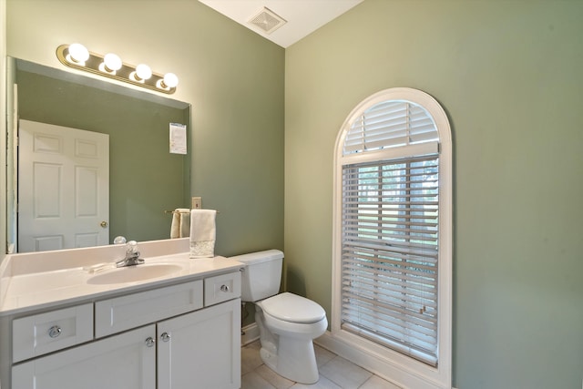 bathroom with tile patterned floors, vanity, and toilet